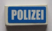 Part 3069pb0447 - Tile 1 x 2 with White 'POLIZEI' on Blue Background Pattern (Sticker) - Sets 7235-2 / 7236-2 / 7744 - De BrickPlaats