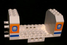 Part 42605pb03 - Aircraft Fuselage Angular Bottom 6 x 12 x 5 with Windows on Orange & Blue Stripes Pattern - De BrickPlaats